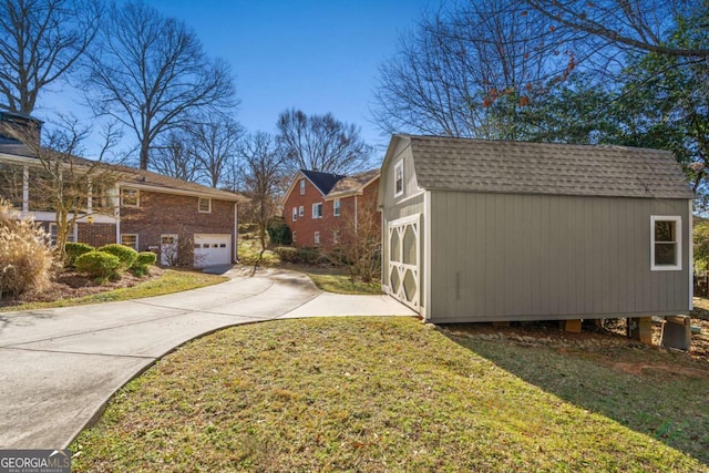 view of home's exterior featuring an outbuilding, a yard, a storage shed, and roof with shingles