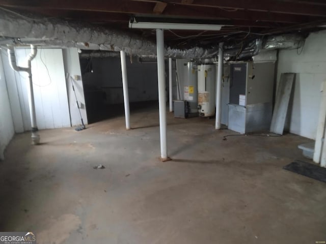 unfinished basement featuring heating unit and water heater