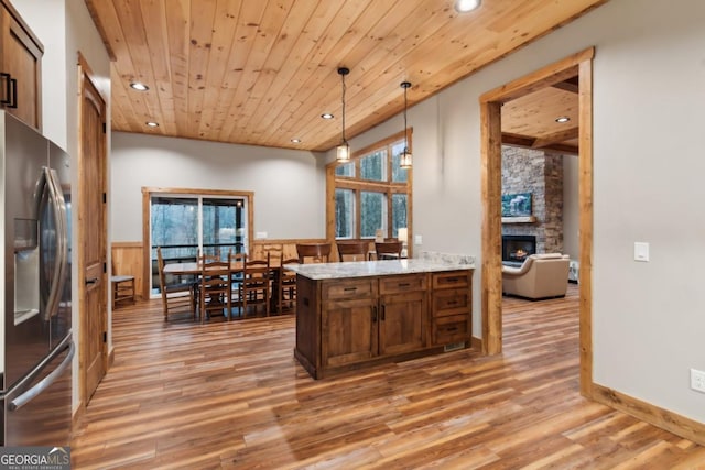 kitchen with stainless steel fridge, wooden ceiling, a wainscoted wall, hanging light fixtures, and recessed lighting