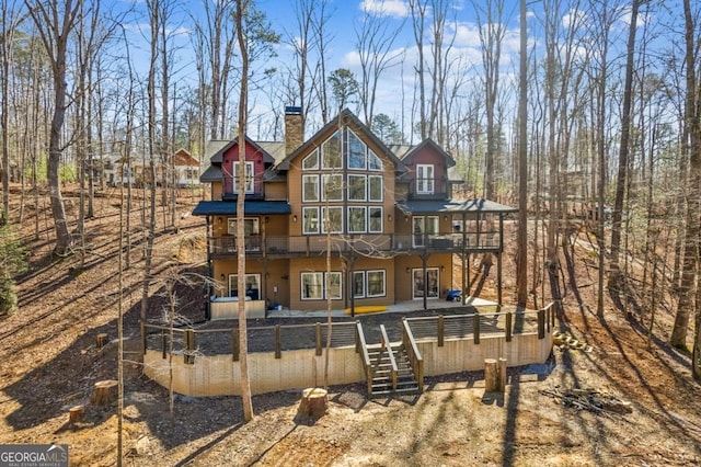 rear view of property featuring a chimney