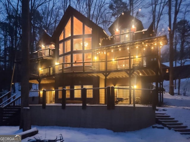 snow covered property with a balcony