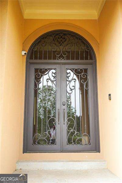 doorway to property with french doors and stucco siding