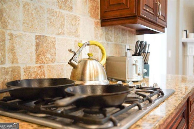 room details with light stone countertops and tasteful backsplash