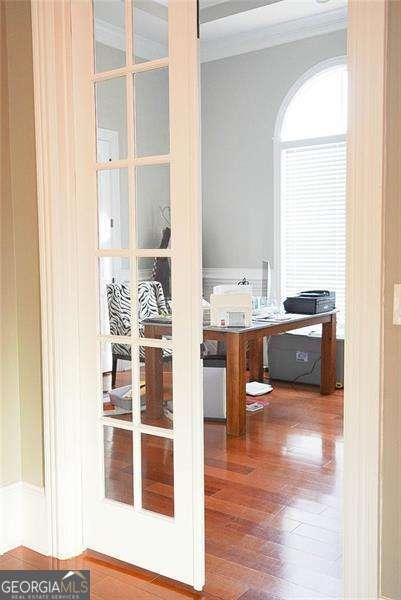 office area featuring french doors, wood finished floors, and crown molding