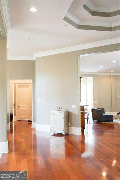 unfurnished room with recessed lighting, crown molding, and wood finished floors