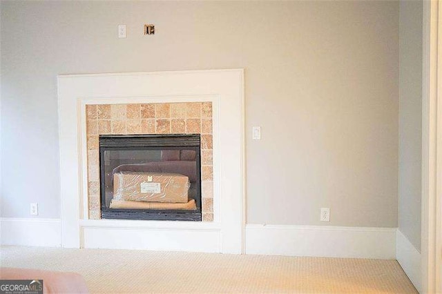 interior details featuring a tiled fireplace