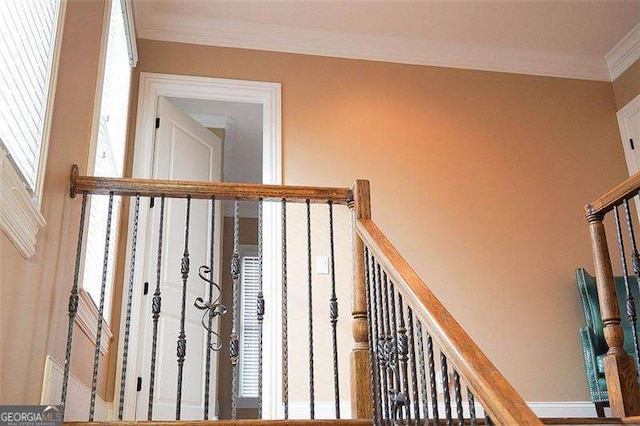 stairs featuring crown molding