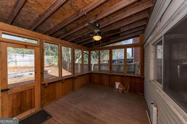 unfurnished sunroom featuring vaulted ceiling and a ceiling fan