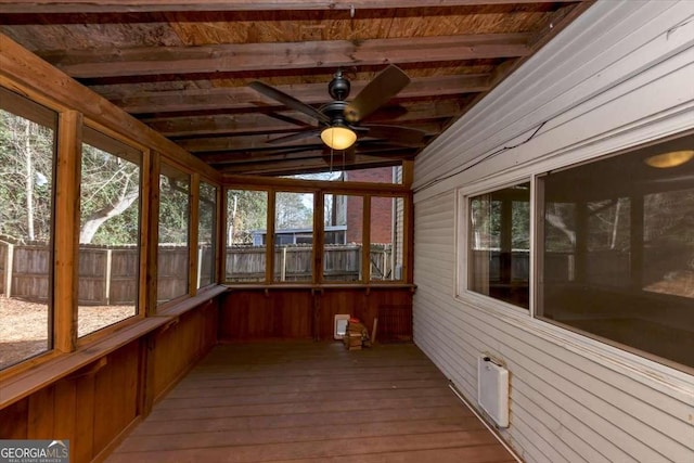 unfurnished sunroom with plenty of natural light, ceiling fan, and beam ceiling