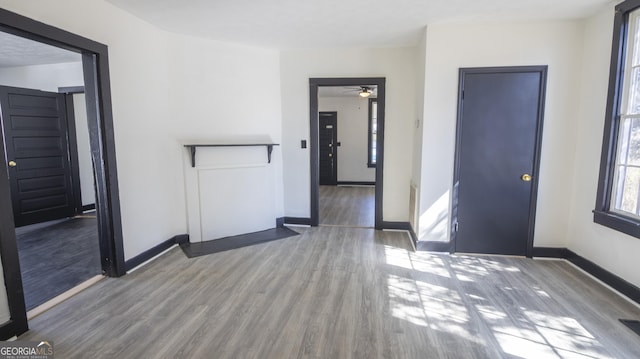 spare room featuring wood finished floors and baseboards