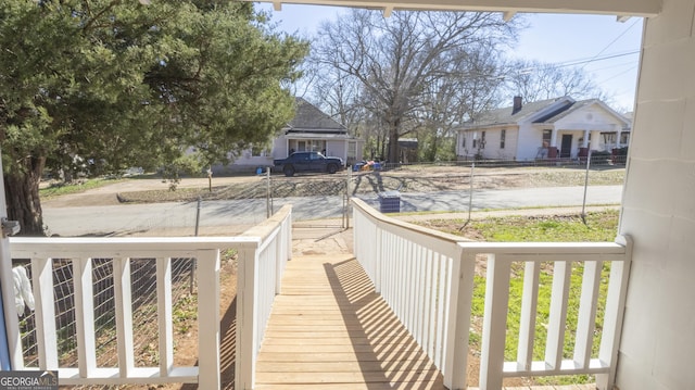 wooden deck featuring a residential view and a porch