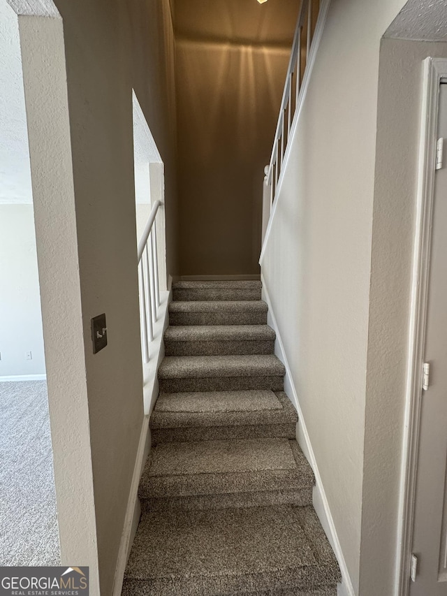 stairway featuring baseboards