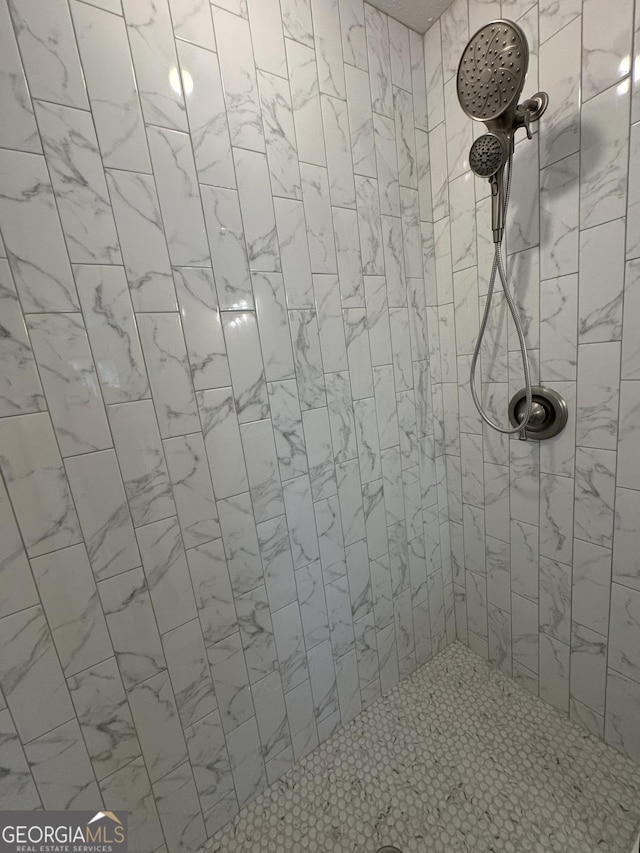 full bath with tiled shower