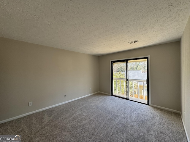 empty room featuring baseboards, visible vents, a textured ceiling, and carpet flooring