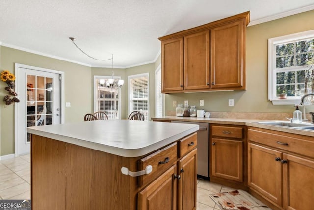 kitchen featuring a sink, light countertops, ornamental molding, brown cabinets, and a center island