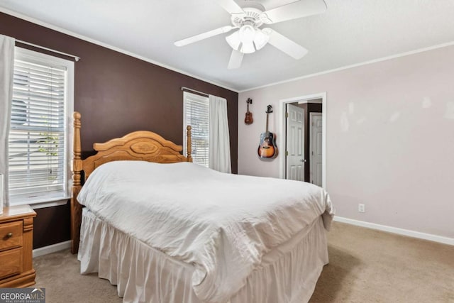 bedroom with crown molding, ceiling fan, light colored carpet, and baseboards