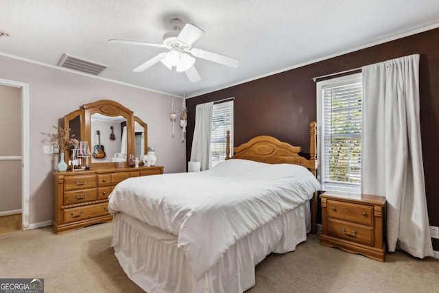 bedroom featuring light colored carpet, a ceiling fan, baseboards, visible vents, and ornamental molding