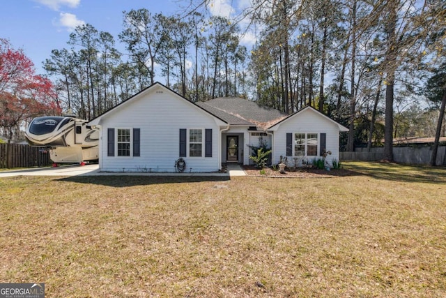 ranch-style house with a front yard and fence