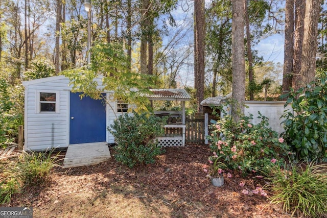 view of front of home with an outbuilding and fence