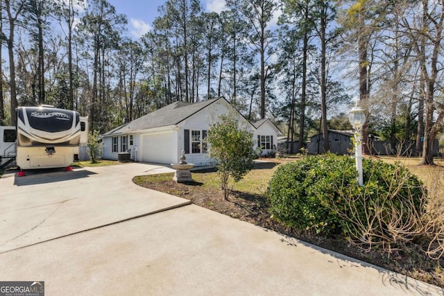 view of side of home with a garage and concrete driveway