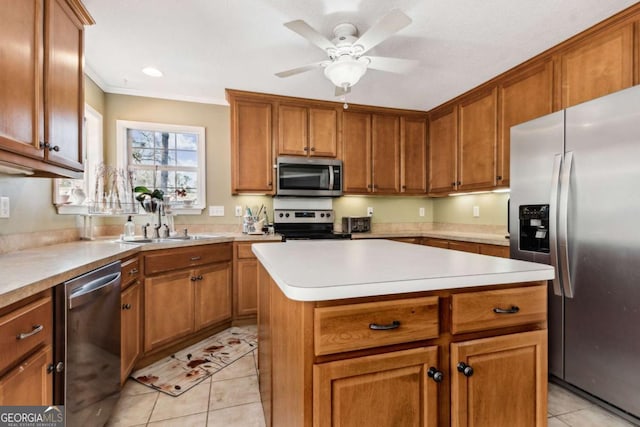 kitchen featuring stainless steel appliances, light countertops, brown cabinetry, and light tile patterned flooring