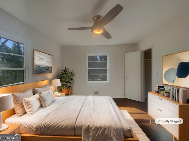 bedroom with visible vents, ceiling fan, and wood finished floors