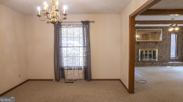 unfurnished dining area featuring a fireplace, carpet flooring, beam ceiling, and baseboards