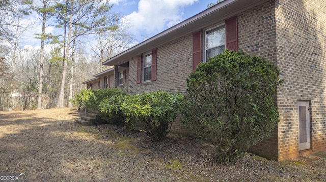 view of property exterior with brick siding