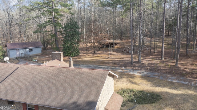 exterior space featuring a shingled roof