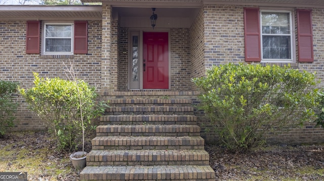 property entrance with brick siding