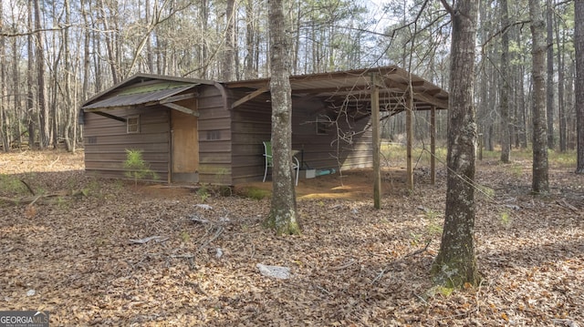 view of outdoor structure featuring a forest view