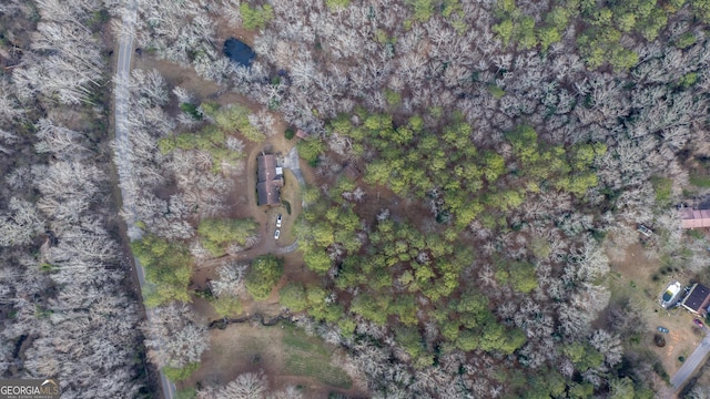 birds eye view of property featuring a wooded view