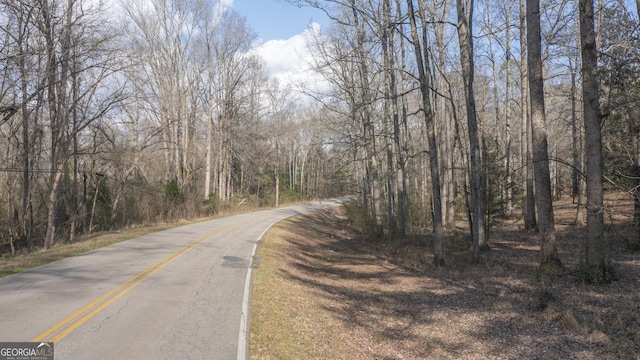 view of road with a forest view