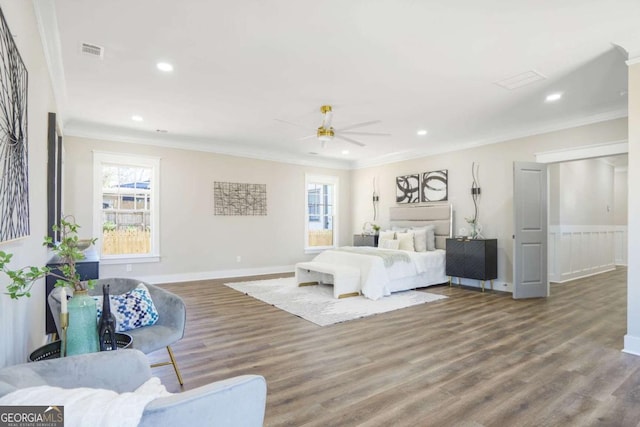 bedroom with recessed lighting, visible vents, ornamental molding, wood finished floors, and baseboards