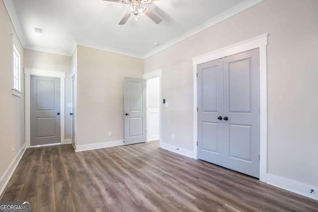 unfurnished bedroom featuring ornamental molding, dark wood-style flooring, visible vents, and baseboards