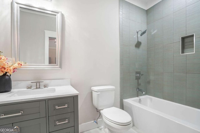 bathroom featuring toilet, bathing tub / shower combination, baseboards, and vanity