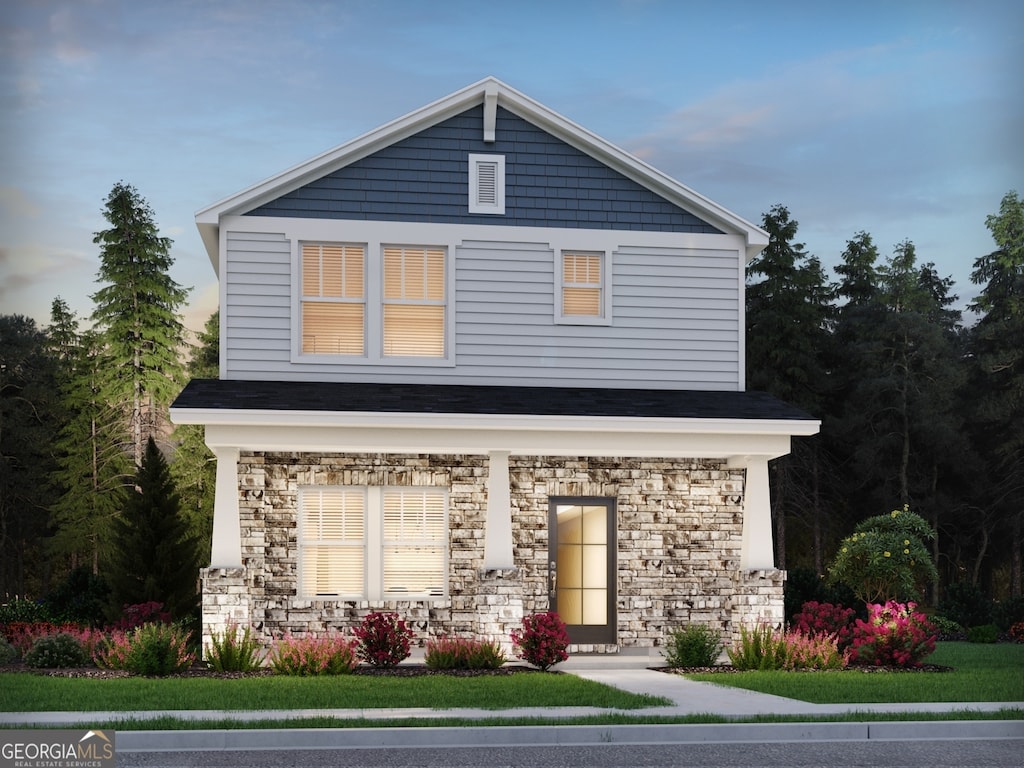 view of front facade with stone siding and covered porch