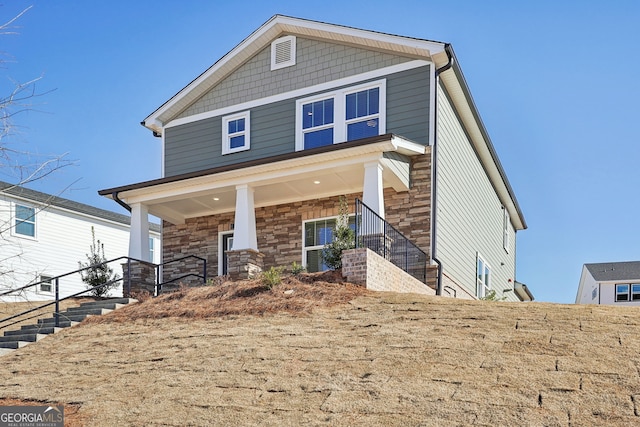 view of front facade featuring stone siding and a porch