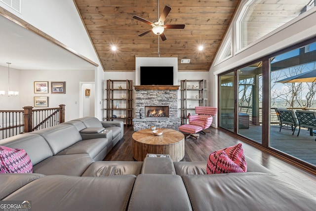 living area featuring high vaulted ceiling, a stone fireplace, wooden ceiling, wood finished floors, and visible vents