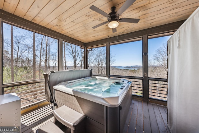 sunroom with wooden ceiling and a jacuzzi