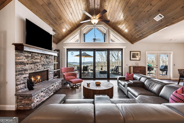 living area featuring wood ceiling, french doors, wood finished floors, and visible vents