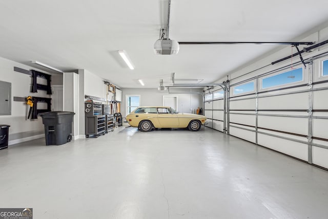 garage featuring electric panel and a garage door opener