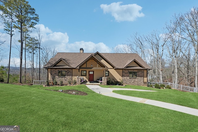 craftsman inspired home featuring a chimney, a shingled roof, a front yard, fence, and stone siding