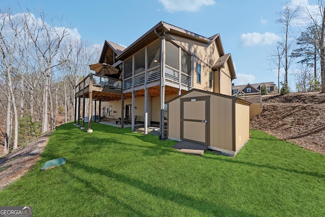 back of property featuring an outbuilding, a sunroom, a yard, and a shed