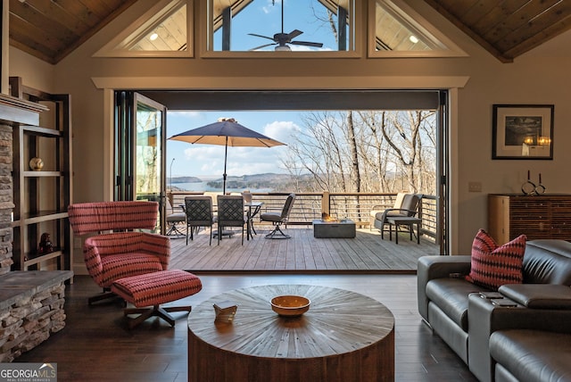 living room with a ceiling fan, wooden ceiling, a mountain view, and wood finished floors