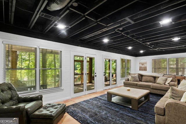 living area with french doors, plenty of natural light, and visible vents