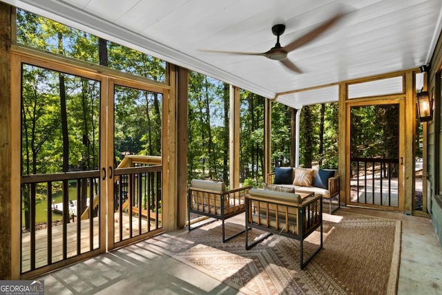 sunroom / solarium featuring a ceiling fan and a healthy amount of sunlight