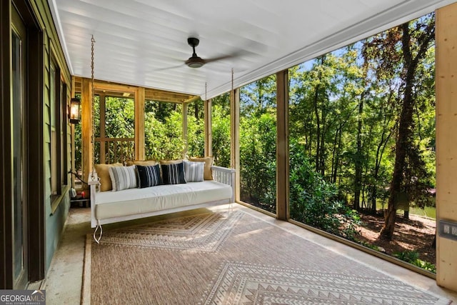 unfurnished sunroom with a ceiling fan