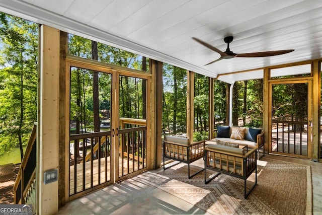 sunroom / solarium featuring ceiling fan