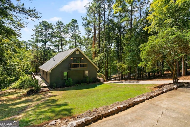 view of side of property with a yard